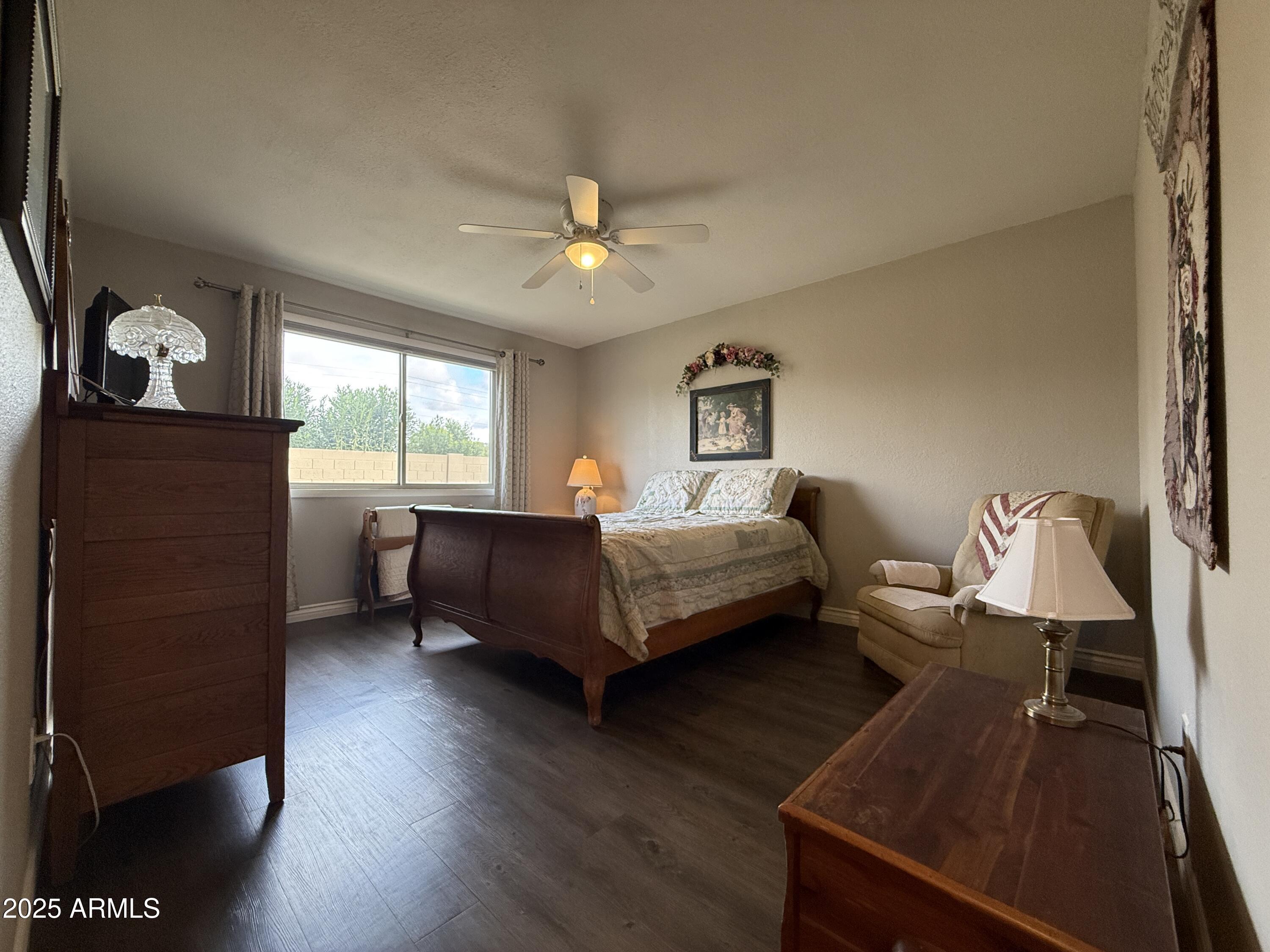 25208 South Angora Court Sun Lakes, AZ 85248 - Photo 20 of 22 a bedroom with a bed and wooden floor