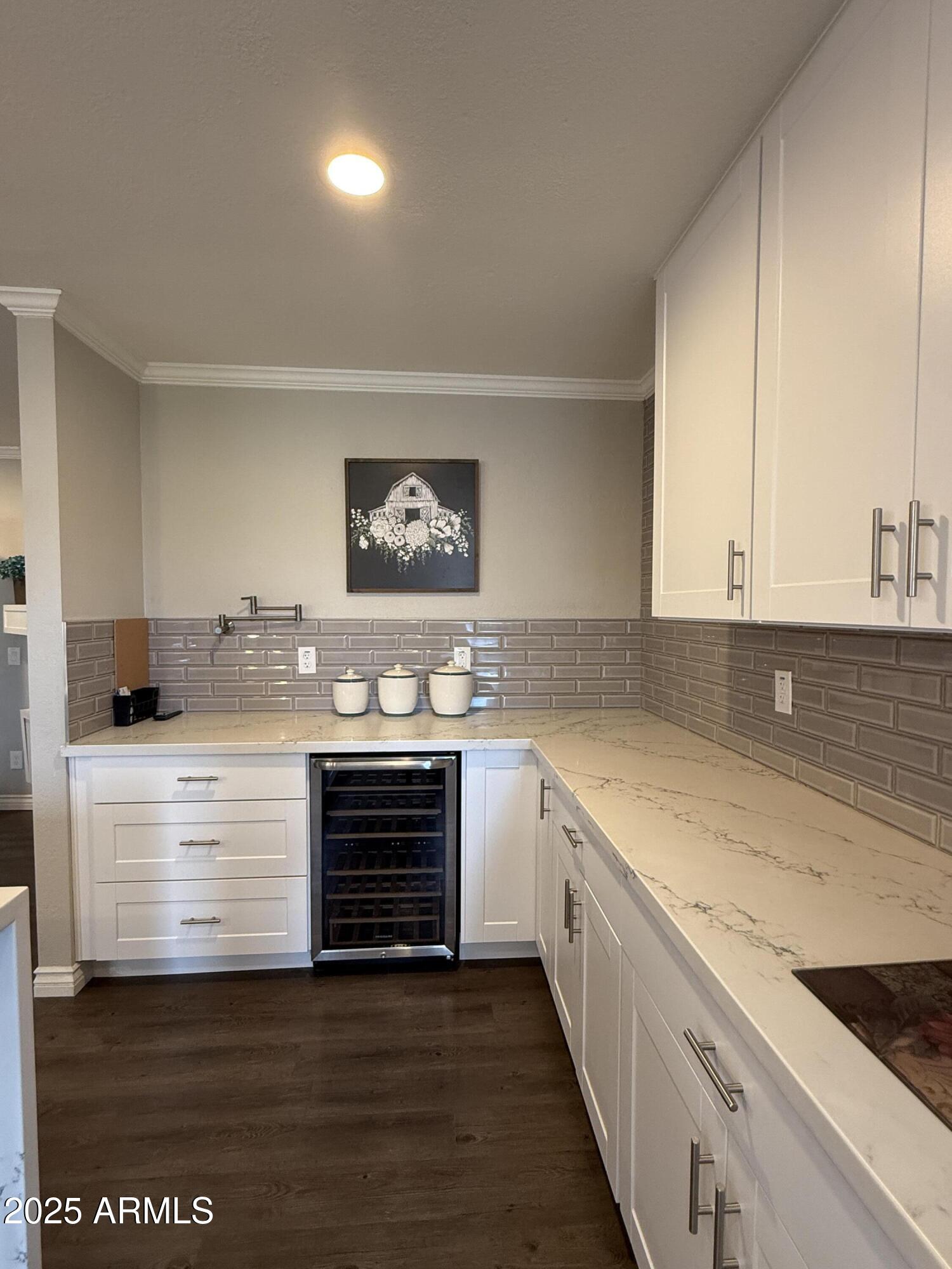 25208 South Angora Court Sun Lakes, AZ 85248 - Photo 6 of 22 a kitchen with granite countertop white cabinets and white appliances