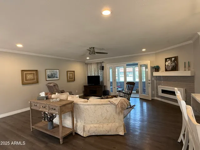 a living room with fireplace furniture and a wooden floor