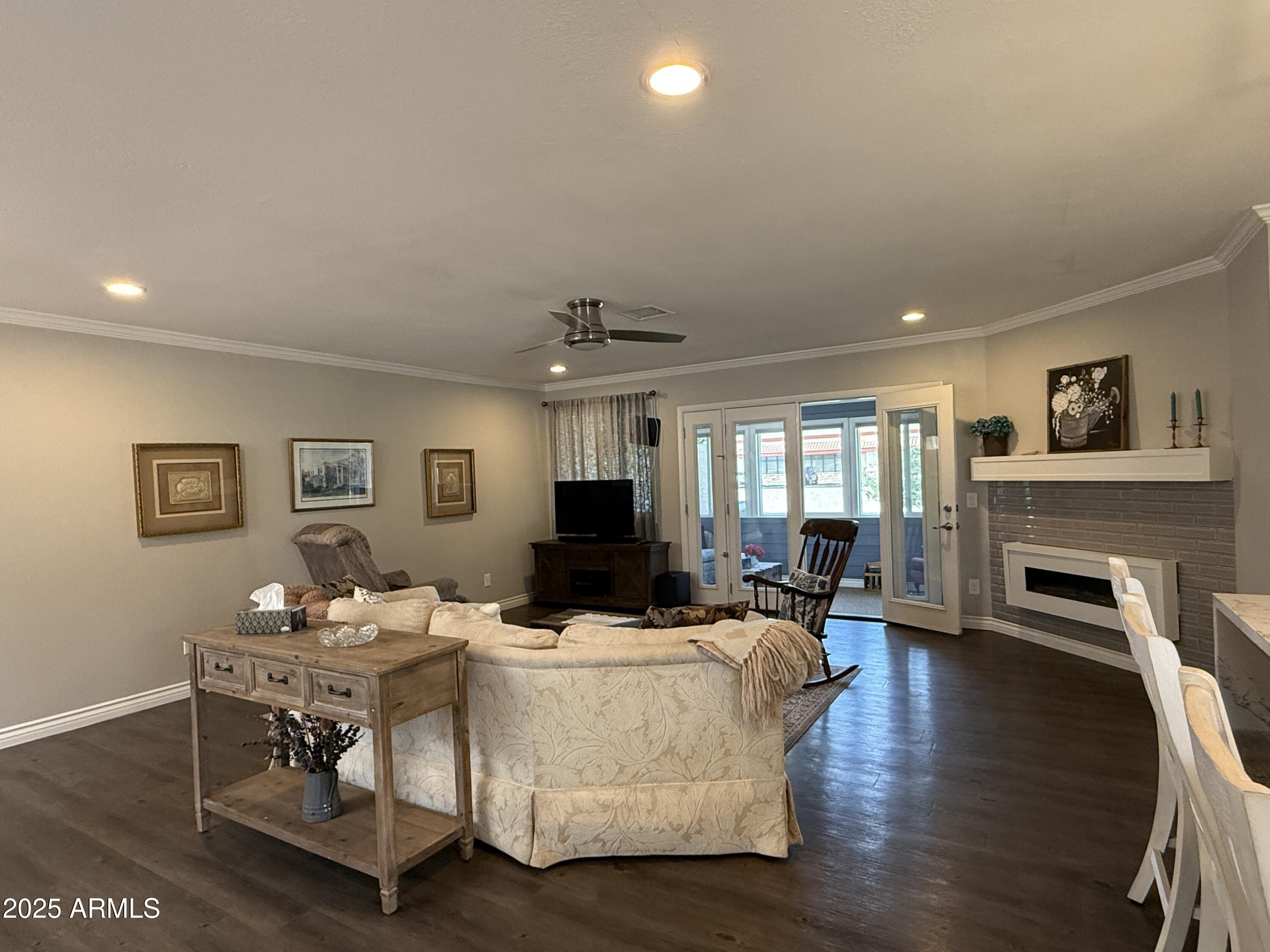 25208 South Angora Court Sun Lakes, AZ 85248 - Photo 8 of 22 a living room with fireplace furniture and a wooden floor