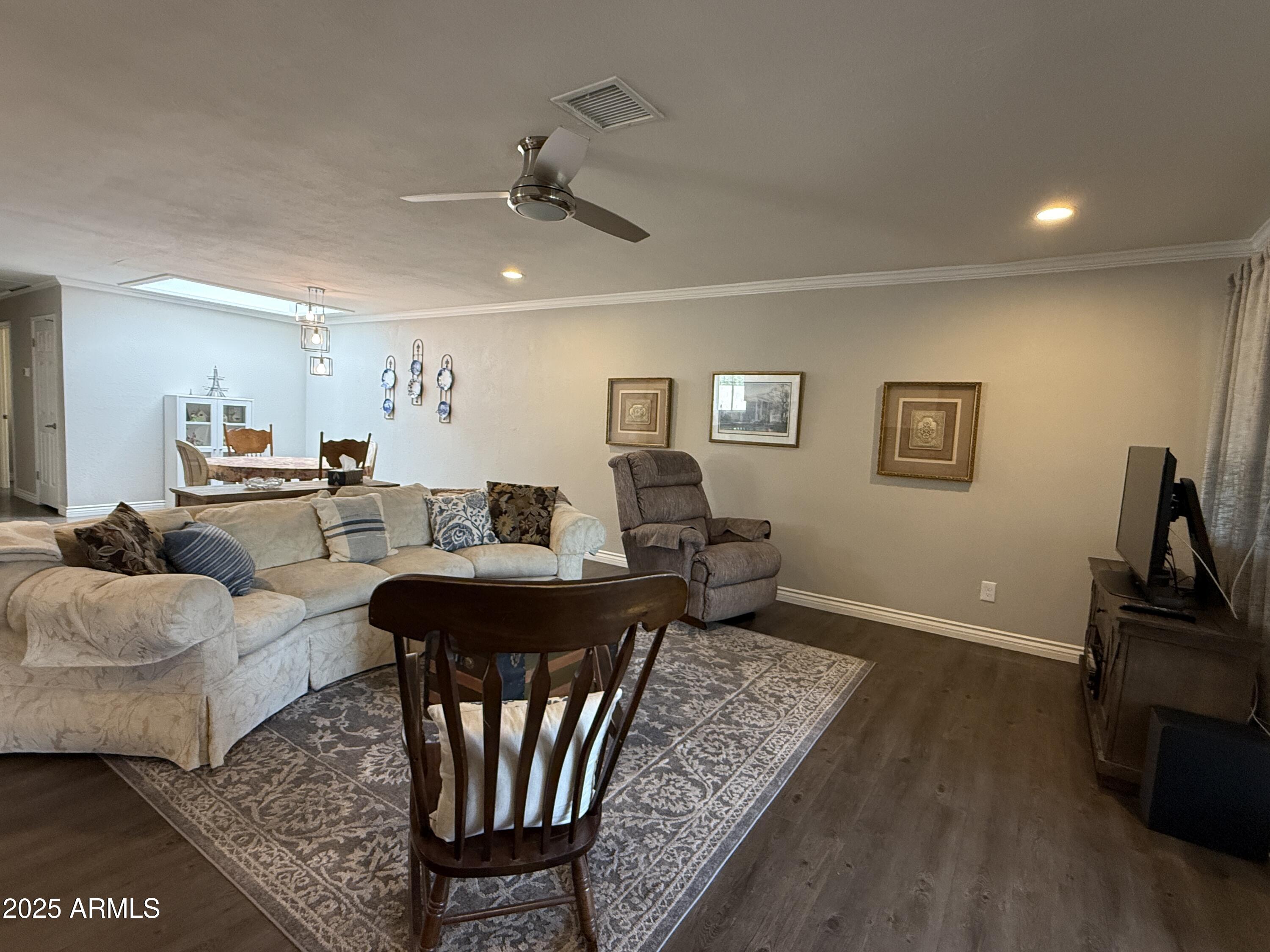 25208 South Angora Court Sun Lakes, AZ 85248 - Photo 9 of 22 a living room with furniture a ceiling fan and a rug
