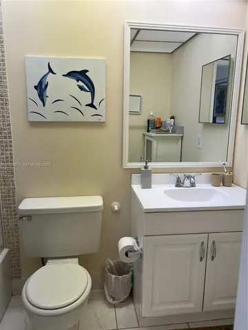 a white toilet sitting next to a bathroom sink