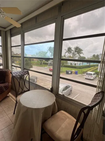 a view of a room with furniture and a large window