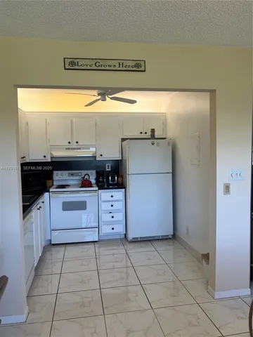 a view of a hallway with a dining table and chairs