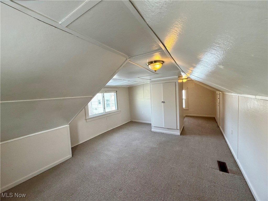 34 West Lewis Street Struthers, OH 44471 - Photo 9 of 14 Bonus room featuring vaulted ceiling, carpet flooring, and a textured ceiling