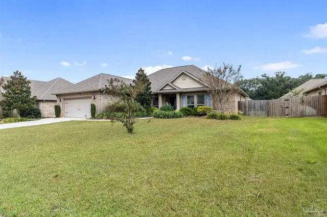 a kitchen with granite countertop a table chairs stove refrigerator and microwave