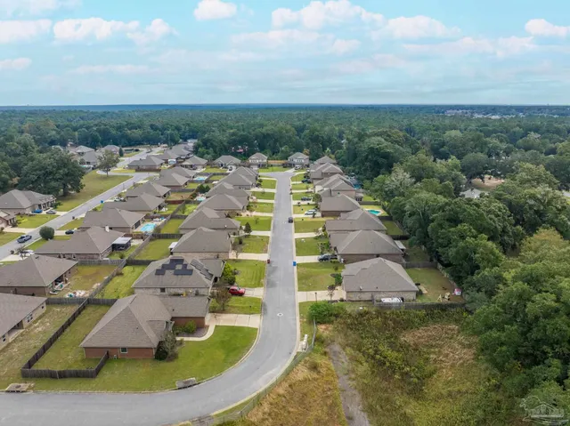 a view of a workspace with wooden floor and a window