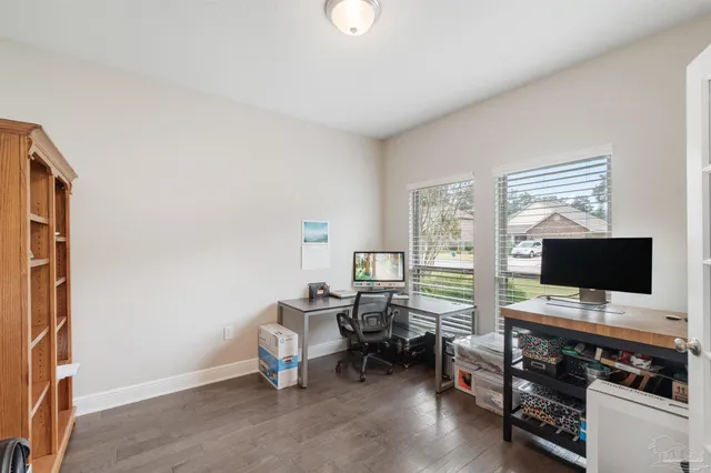 a bed sitting in a bedroom next to a window and a chandelier