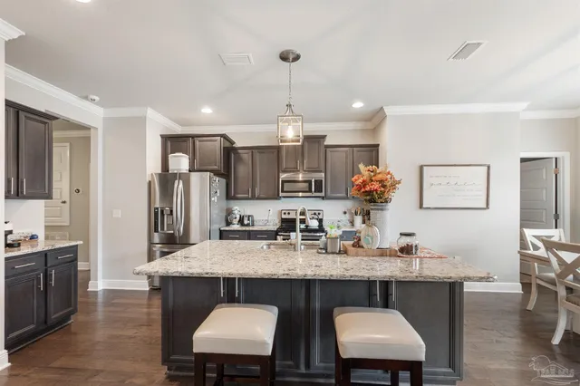 a living room with furniture and a view of kitchen