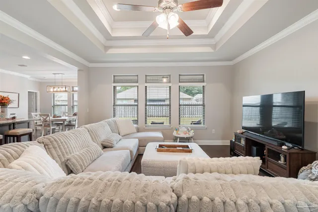 a bedroom with a bed and a chandelier fan