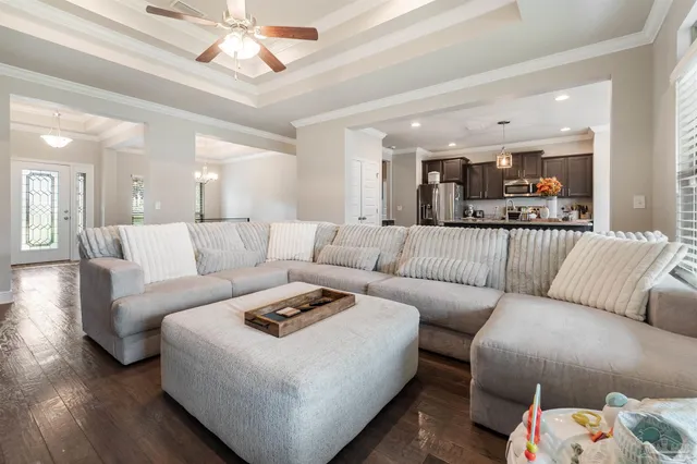 a kitchen with granite countertop kitchen island stainless steel appliances a sink stove and refrigerator