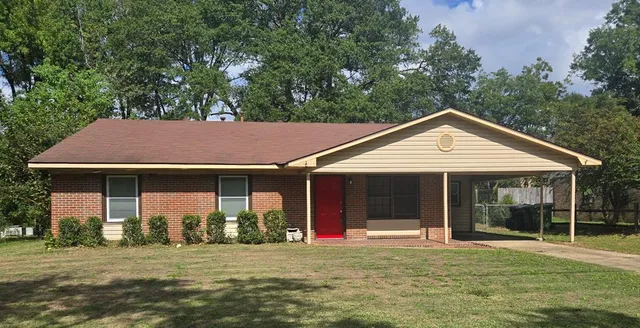 a view of a house with a yard and porch