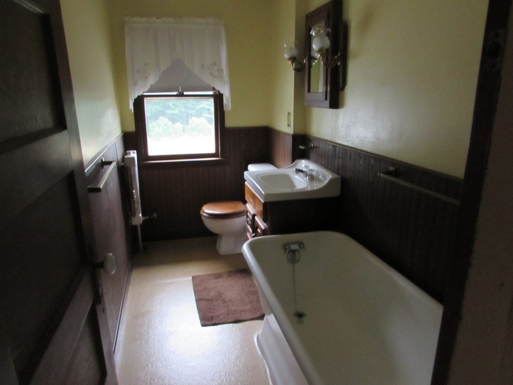 37 Barrison Street Springfield, MA 01109 - Photo 11 of 17 a bathroom with a toilet sink and mirror