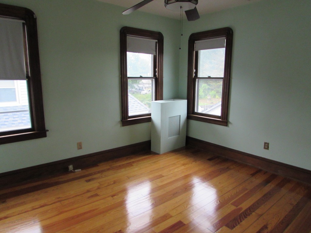 37 Barrison Street Springfield, MA 01109 - Photo 12 of 17 an empty room with wooden floor and windows
