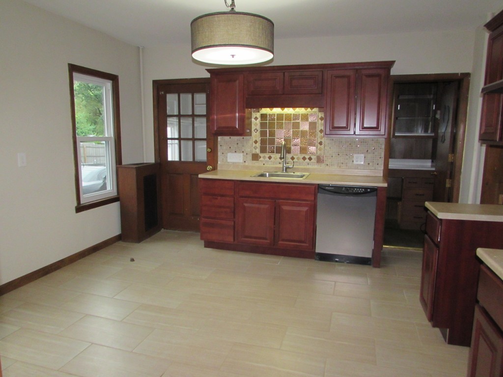 37 Barrison Street Springfield, MA 01109 - Photo 3 of 17 a kitchen with granite countertop a stove cabinets and wooden floor