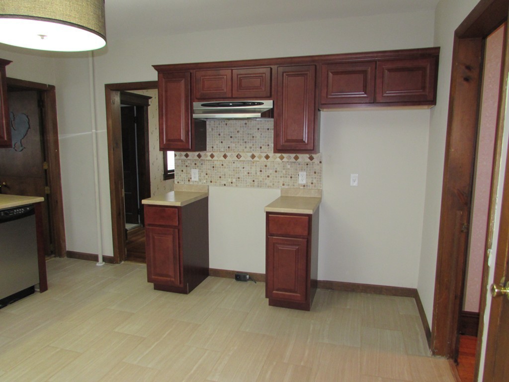 37 Barrison Street Springfield, MA 01109 - Photo 4 of 17 a kitchen with a refrigerator and cabinets