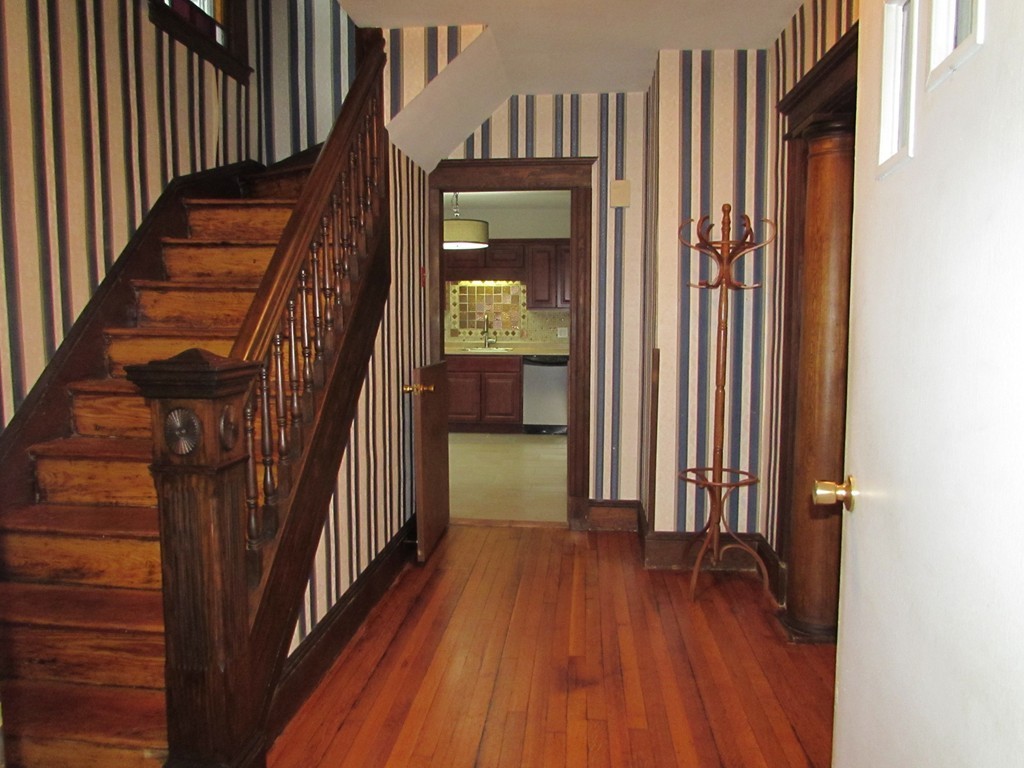 37 Barrison Street Springfield, MA 01109 - Photo 7 of 17 a view of a hallway with wooden floor and staircase
