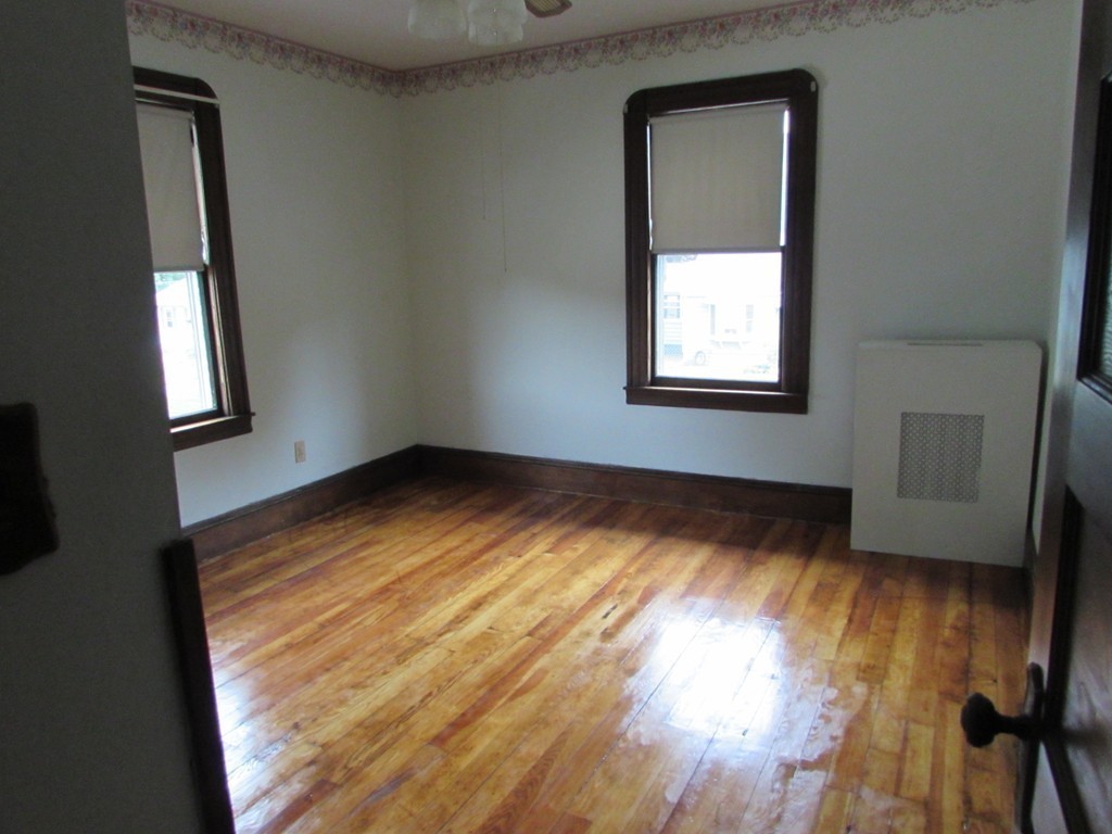 37 Barrison Street Springfield, MA 01109 - Photo 9 of 17 an empty room with wooden floor and windows