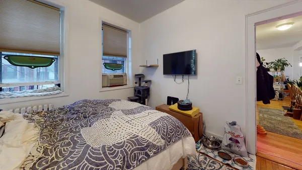 a bedroom with a bed and flat screen tv