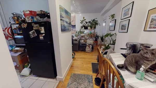 a living room with furniture and flowers