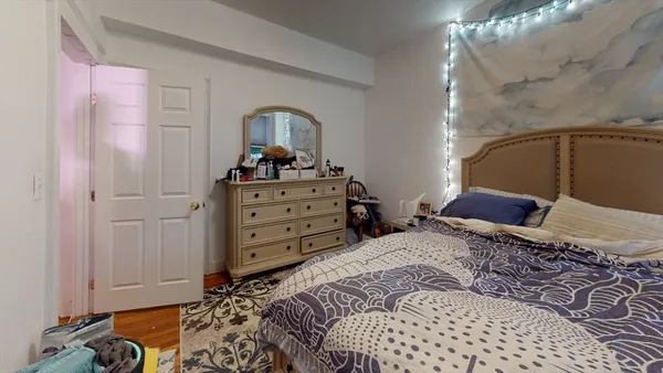 a bedroom with a bed and a dresser