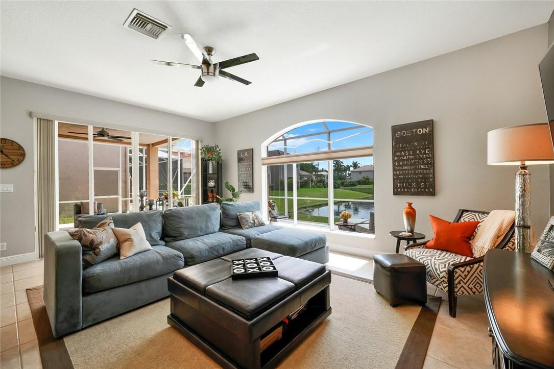 9685 Vineyard Court Boca Raton, FL 33428 - Photo 12 of 45 a living room with furniture a ceiling fan and a large window
