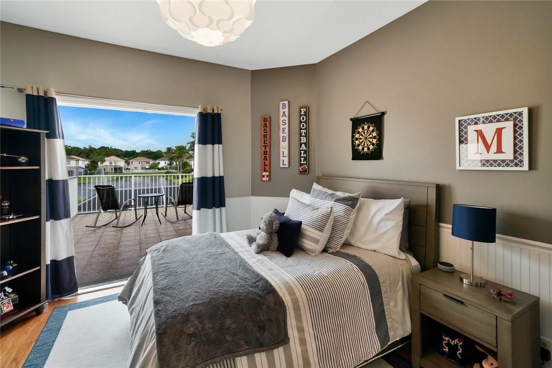 9685 Vineyard Court Boca Raton, FL 33428 - Photo 25 of 45 a bedroom with a bed and wooden floor