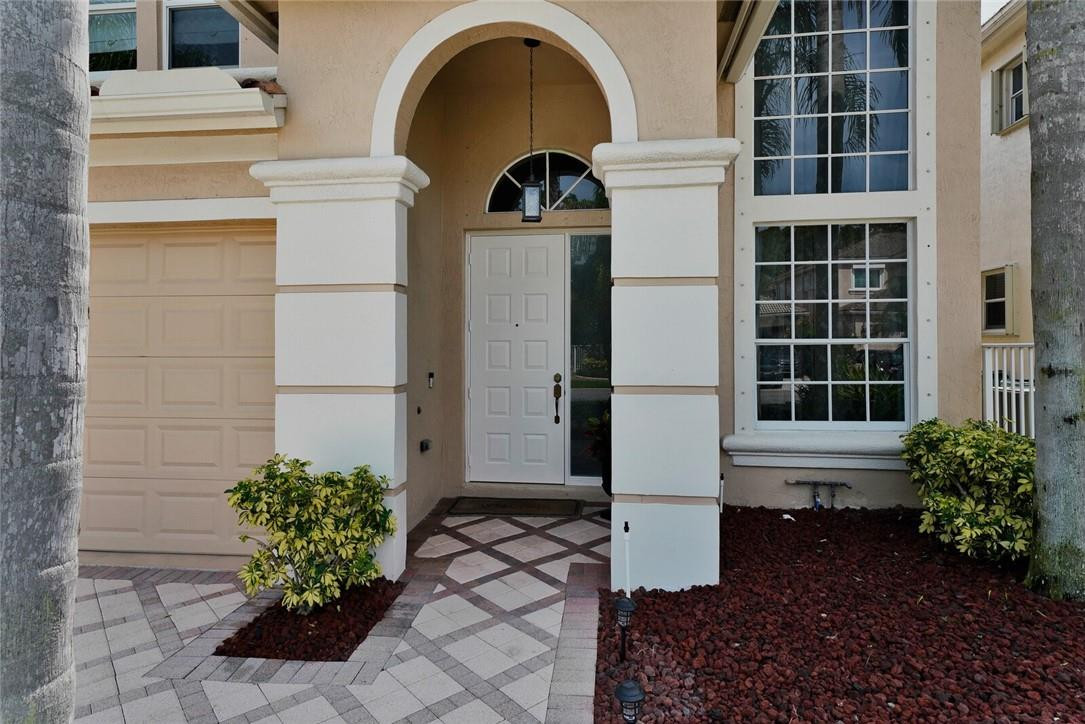 9685 Vineyard Court Boca Raton, FL 33428 - Photo 3 of 45 a front view of a house