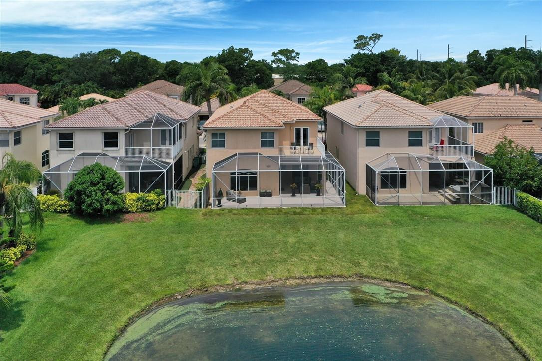 9685 Vineyard Court Boca Raton, FL 33428 - Photo 38 of 45 a view of a white house with a big yard and large trees