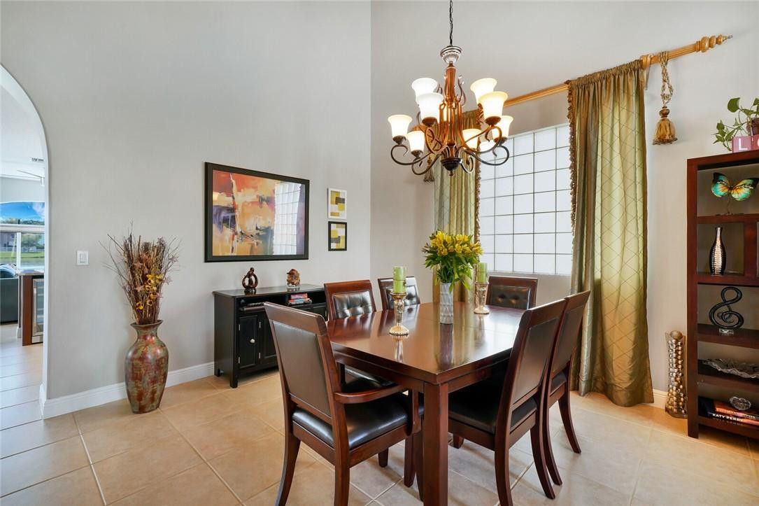 9685 Vineyard Court Boca Raton, FL 33428 - Photo 7 of 45 a view of a dining room with furniture and chandelier