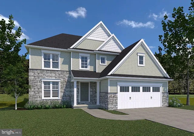 a front view of a house with a garden and yard