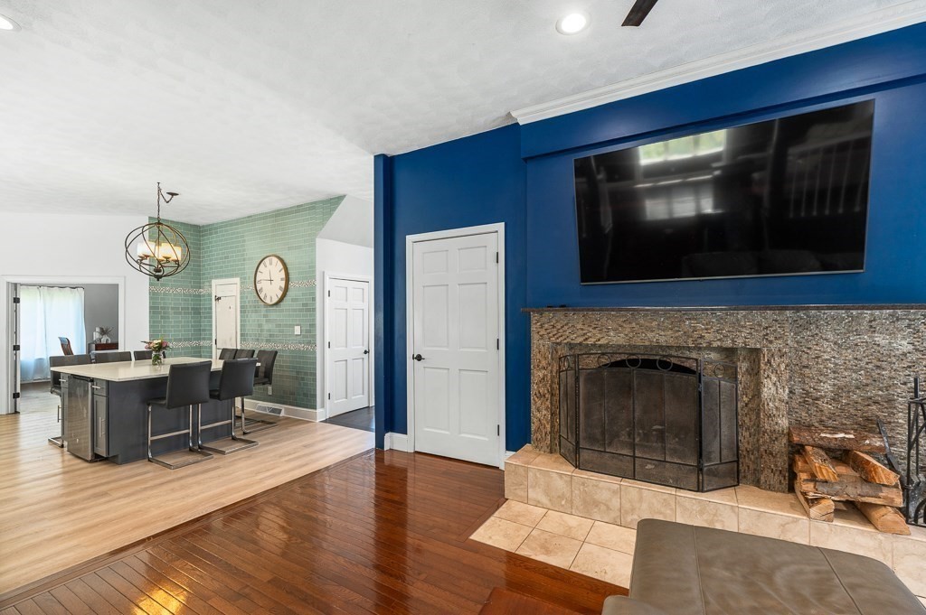 20 Landers Road Stoneham, MA 02180 - Photo 13 of 36 a living room with furniture a flat screen tv and a fireplace