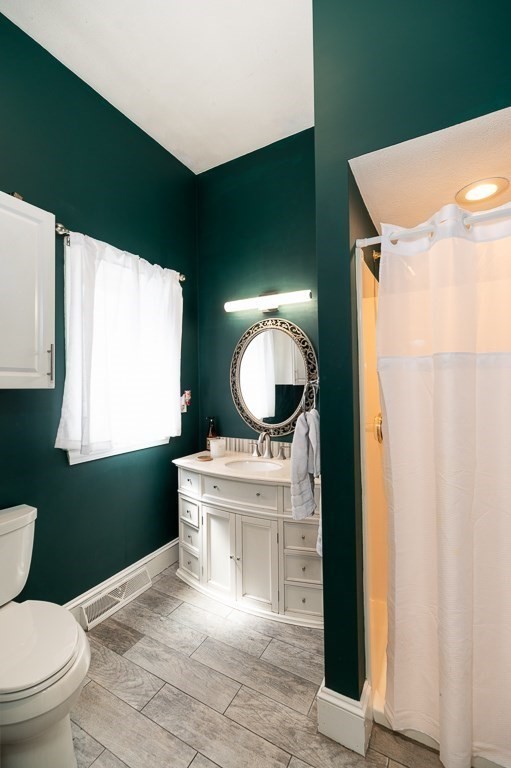 20 Landers Road Stoneham, MA 02180 - Photo 18 of 36 a bathroom with a toilet sink and mirror