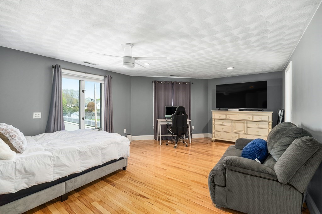 20 Landers Road Stoneham, MA 02180 - Photo 20 of 36 a bedroom with furniture and a flat screen tv