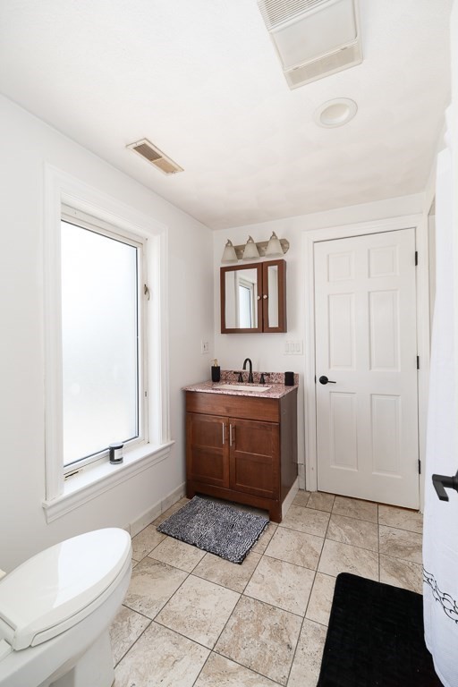 20 Landers Road Stoneham, MA 02180 - Photo 22 of 36 a bathroom with a sink a toilet and mirror