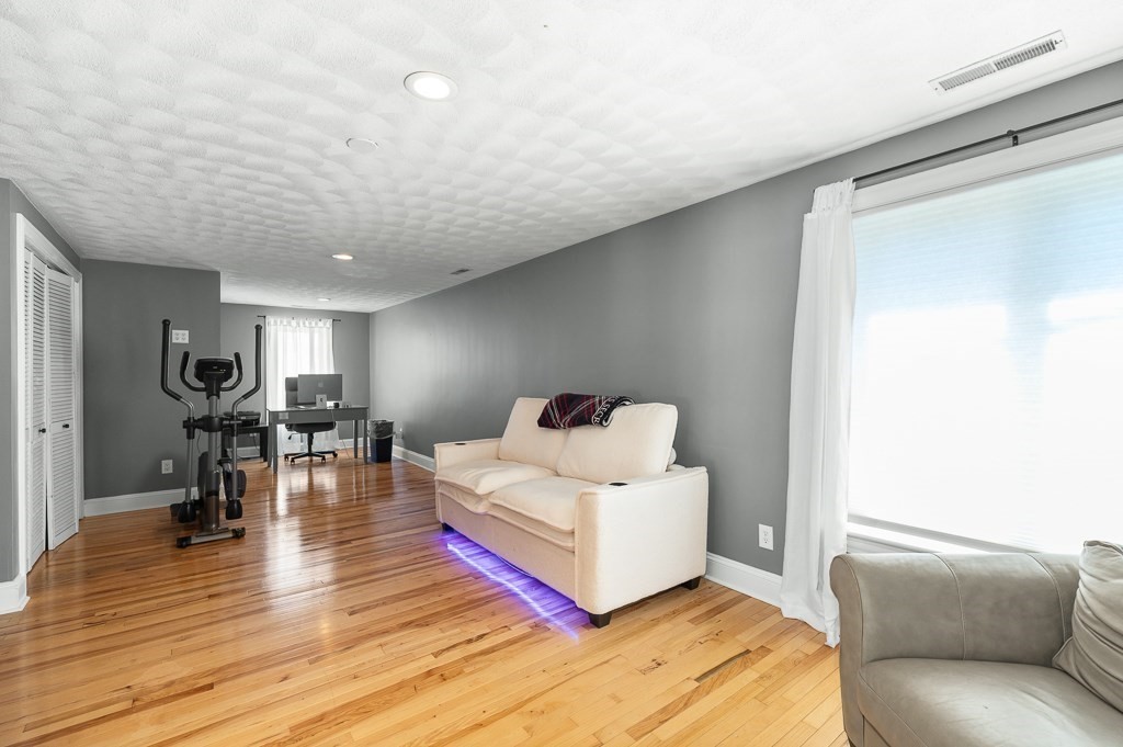 20 Landers Road Stoneham, MA 02180 - Photo 23 of 36 a living room with furniture and a wooden floor