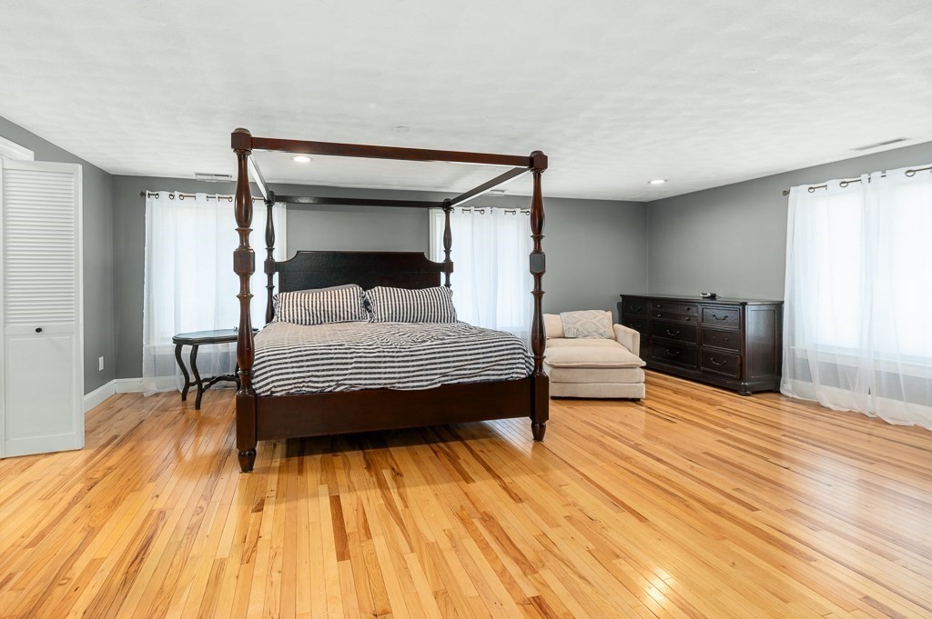 20 Landers Road Stoneham, MA 02180 - Photo 25 of 36 a bedroom with a bed and wooden floor