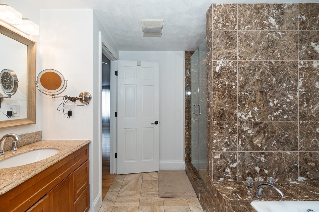 20 Landers Road Stoneham, MA 02180 - Photo 28 of 36 a bathroom with a granite countertop sink a toilet and shower