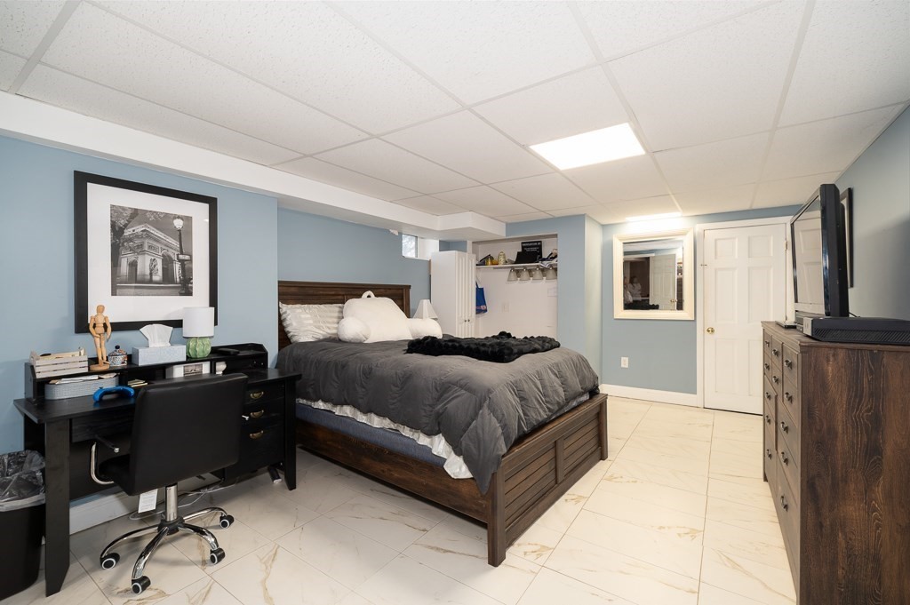 20 Landers Road Stoneham, MA 02180 - Photo 29 of 36 a spacious bedroom with a bed and a desk