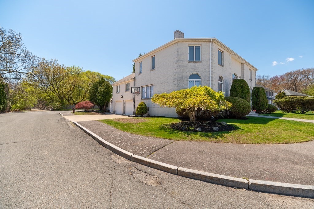 20 Landers Road Stoneham, MA 02180 - Photo 30 of 36 a front view of a house with a yard and garage