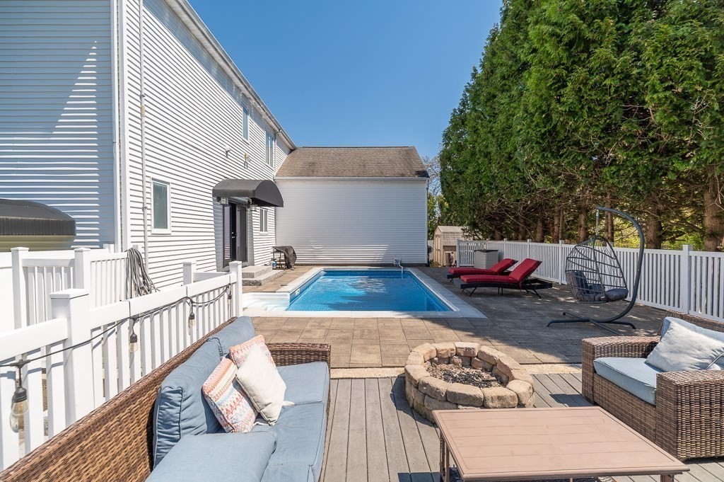 20 Landers Road Stoneham, MA 02180 - Photo 34 of 36 a view of a patio with couches table and chairs and wooden fence