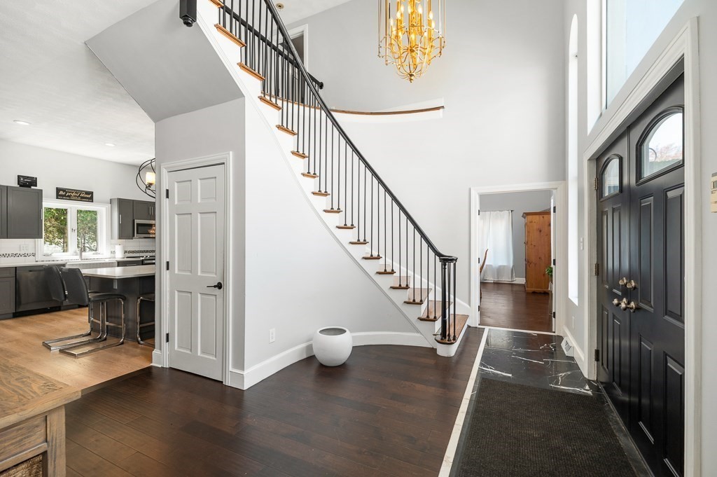 20 Landers Road Stoneham, MA 02180 - Photo 6 of 36 a view of hallway with stairs and wooden floor