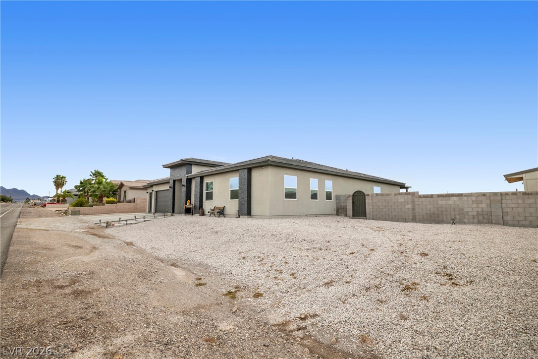 432 North Racetrack Road Henderson, NV 89015 - Photo 36 of 45 Rear view of property with a garage and driveway