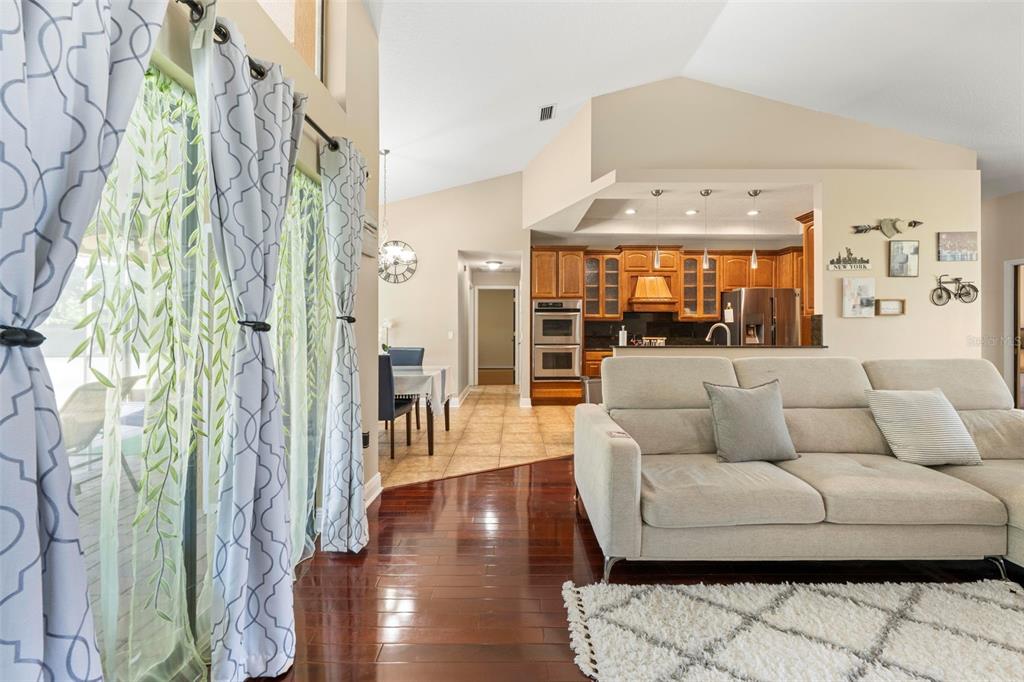 14207 Cornewall Lane Spring Hill, FL 34609 - Photo 13 of 63 a living room with furniture and a floor to ceiling window
