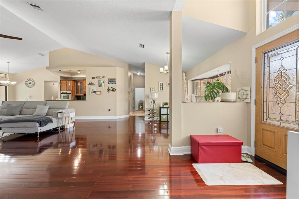 14207 Cornewall Lane Spring Hill, FL 34609 - Photo 19 of 63 a living room with furniture wooden floor and a rug
