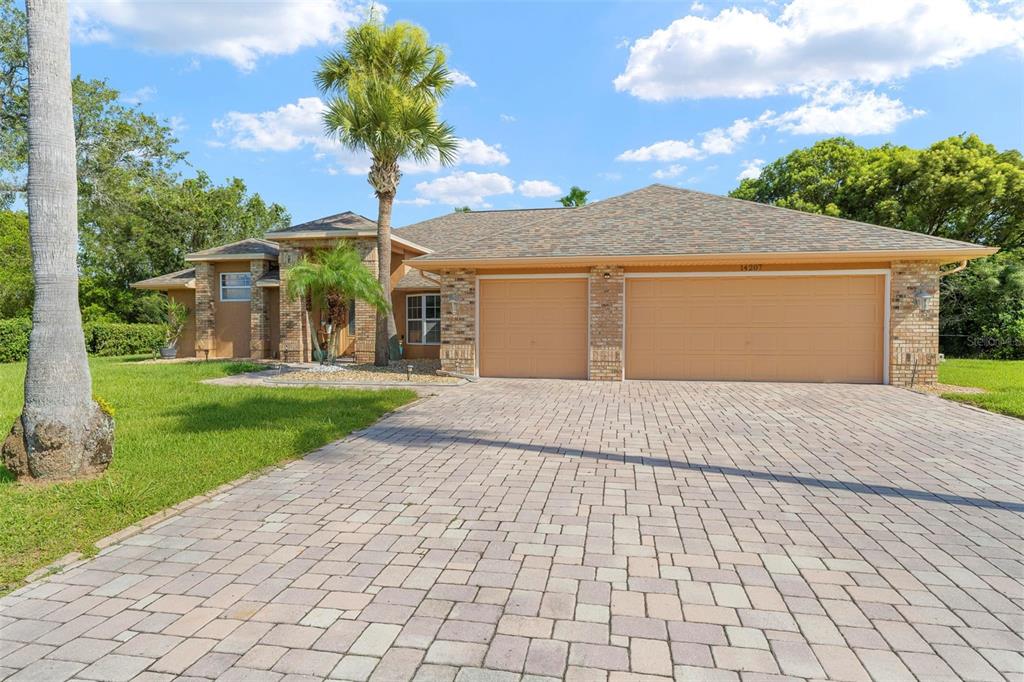 14207 Cornewall Lane Spring Hill, FL 34609 - Photo 4 of 63 a front view of house with yard and green space