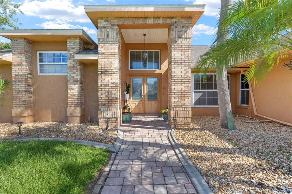 14207 Cornewall Lane Spring Hill, FL 34609 - Photo 5 of 63 a front view of a house with a yard