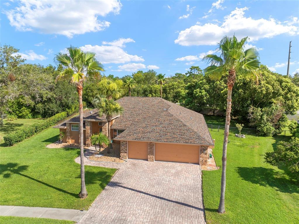 14207 Cornewall Lane Spring Hill, FL 34609 - Photo 63 of 63 a view of a house with backyard and garden