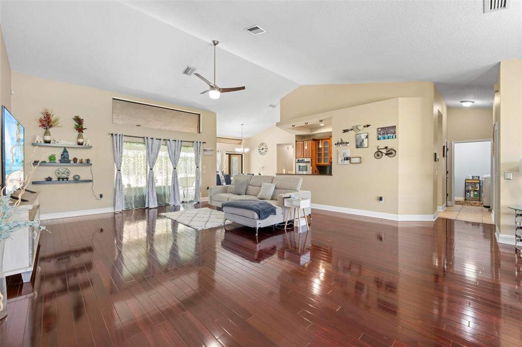 14207 Cornewall Lane Spring Hill, FL 34609 - Photo 7 of 63 a living room with fireplace furniture and a wooden floor