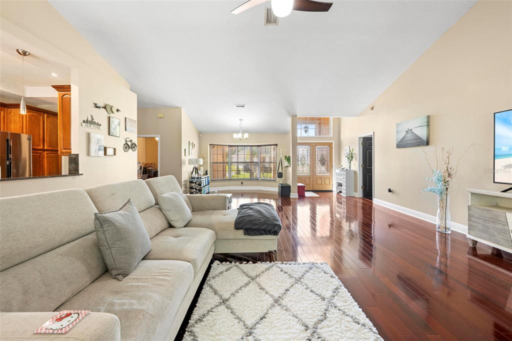 14207 Cornewall Lane Spring Hill, FL 34609 - Photo 9 of 63 a living room with furniture and a wooden floor